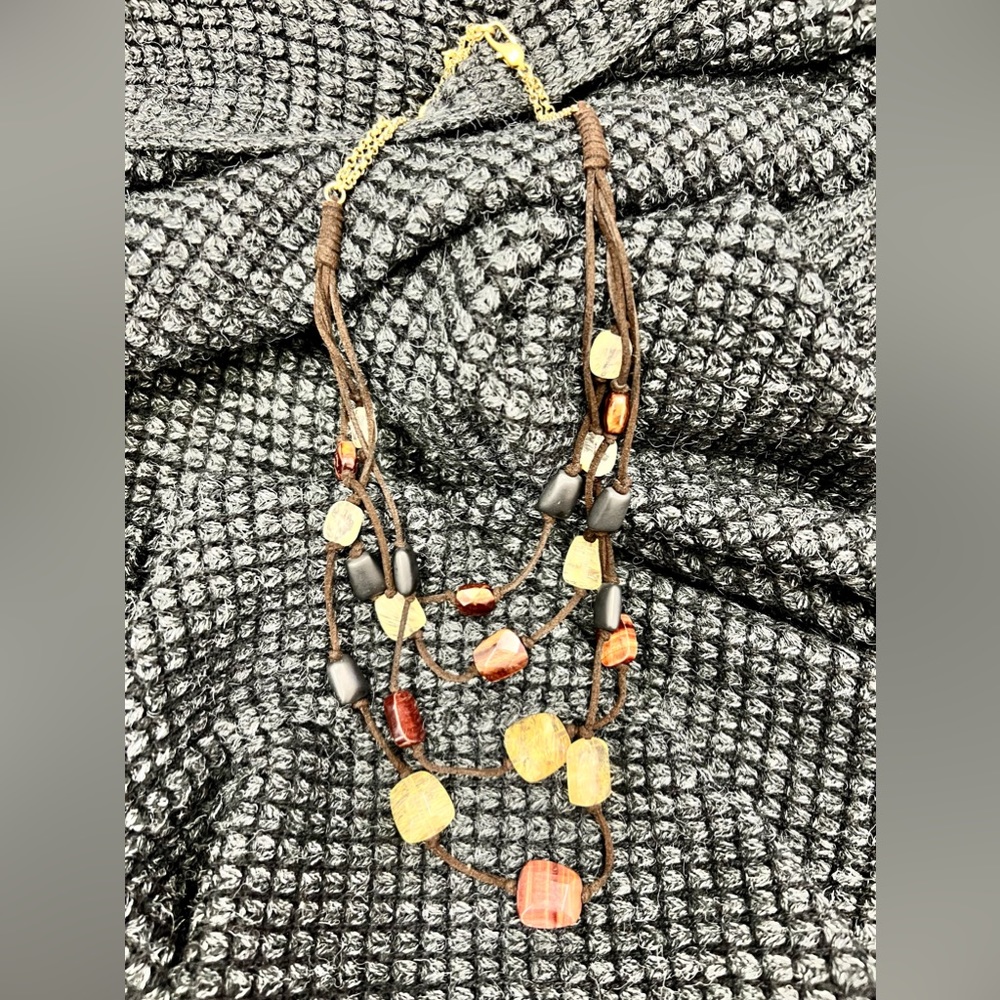 Kenneth Cole gold and suede necklace with authentic natural stones. Hangs 12”
